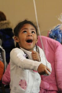 A little girl plays with a balloon during Rhonda Klch’s Holiday Dream event. Photo by Giselle Barkley 