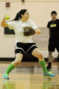 Ward Melville senior left fielder Mary Garr winds up to throw the ball across the gym during practice Monday. Photo by Bill Landon