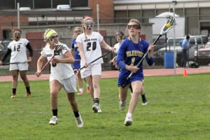 Hannah Dorney, a Comsewogue midfielder, crosses into Deer Park's zone on her way to a double hat trick and the Warriors' 17-7 win on April 27. Photo by Desirée Keegan