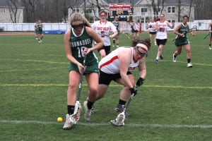 Harborfields’ Caitlin Schaefer, who finished the game with six goals, scoops up a ground ball. Photo by Desirée Keegan