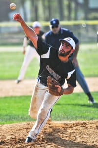 Comsewogue’s Dan Colasanto, who went 2-for-4 with a run and an RBI, hurls a pitch from the mound in the Warriors’ 7-4 win over Westhampton on May 11. The win helped Comsewogue claim sole possession of first place with a 16-3 mark in League VI. Photo by Bill Landon