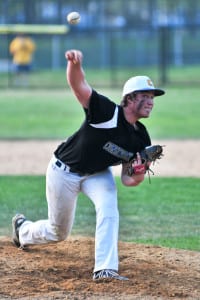 Comsewogue’s Mike Stiles tosses a pitch in a 1-2-3 inning that helped the Warriors claim a 7-4 win over Westhampton on May 11. The win helped Comsewogue claim sole possession of first place with a 16-3 mark in League VI. Photo by Bill Landon