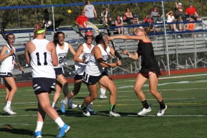 Middle Country’s Jamie Ortega shoots the ball over a swarm of Smithtown West players in her team’s 17-13 win over the Bulls on May 8. With the win, the Mad Dogs finished the regular season undefeated at 16-0, with a 14-0 mark in Division I. Photo by Desirée Keegan