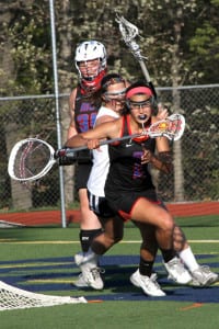 Middle Country’s Nikki Ortega gains possession of the ball in the Mad Dogs’ zone, in her team’s 17-13 win over Smithtown West on May 8. With the win, Middle Country finished the regular season undefeated at 16-0, with a 14-0 mark in Division I. Photo by Desirée Keegan