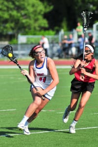 Alison DiPaola moves the ball up the field for Middle Country. Photo by Bill Landon
