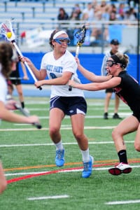 Rocky Point’s Madison Sanchez maintains possession of the ball at Mount Sinai’s Sydney Pirreca checks her, in the Mustangs’ 10-5 win over the Eagles May 9. Photo by Bill Landon