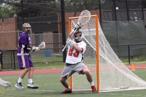 Mount Sinai’s Charlie Faughnan deflects the ball away from the net in the Mustangs’ 6-4 win over Islip on May 18, in the first round of the Division I Class A playoffs. Photo by Desirée Keegan