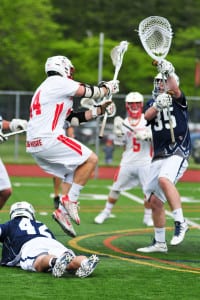 Smithtown East’s John Daniggelis shoots the ball while Smithtown West’s Zach Lamberti hoists his stick up to defend in the Division I semifinal game on May 22 where East topped it crosstown rival 17-11. Photo by Bill Landon