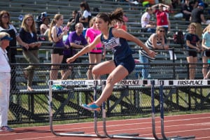 Alexandra Koumas leaps over the hurdle for Huntington. Photo by Darin Reed