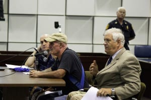 State Assemblyman Steve Englebright, right, and a local fisherman, left, speak at a Brookhaven Town Board meeting. Photo by Erika Karp