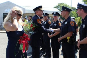 Police Inspector Edward Brady shakes hands with officers at his farewell on Friday, July 17. Photo by Victoria Espinoza.