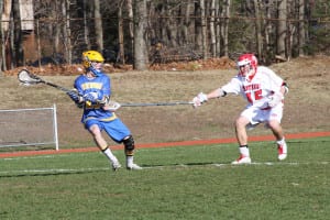 Miller Place's Jacob Bloom reaches out his stick to keep a Comsewogue player at bay in a previous contest. File photo by Desirée Keegan