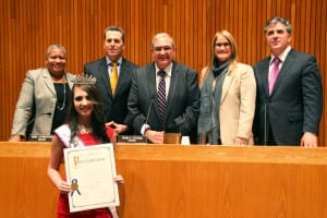 Rachel Goldsmith, Miss Teen New York International, receives a proclamation earlier this year from the Town of Huntington Board of Trustees, from left, Councilwoman Tracey Edwards (D); Councilman Mark Cuthbertson (D); Supervisor Frank Petrone (D), Councilwoman Susan A. Berland (D) and Councilman Gene Cook (I). Photo from Town of Huntington