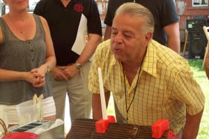 Society President Gerard Mannarino blows out the birthday cake candles. Photo by Erin Dueñas 