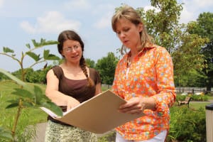 Polly Weigand, left, of the Long Island Native Plant Initiative, and county Legislator Sarah Anker, right, discuss native plant species for Anker’s Educational Agriculture Support Initiative pilot garden at Heritage Park in Mount Sinai. Photo by Giselle Barkley