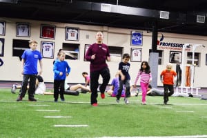Paul Fick, a co-founder of Back in the Game, which helps pediatric cancer patients regain their strength, balance and flexibility, exercises with some of his young patients. Photo from Fick