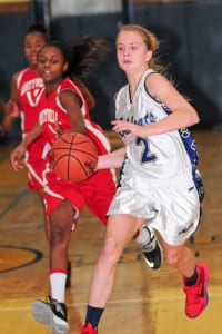 Courtney Clasen races downcourt with the ball. File photo by Bill Landon