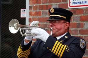 An official plays the bugle at Port Jefferson Fire Department's 13th annual 9/11 memorial ceremony. Photo by Giselle Barkley