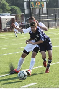 Smithtown's Harrison Weber gets in front of a Ward Melville player as he reaches for possession. Photo by Desirée Keegan