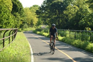 A biker enjoys a section of the Greenway Trail.