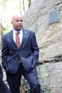 Assembly Speaker Carl Heastie stands in front of Patriots Rock. Photo by Giselle Barkley