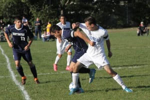 Centereach defender and co-captain Nick Gennardo tries to get the ball out of Cougars territory. Photo by Desirée Keegan