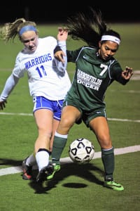 Comsewogue's Jamie Fischer and Harborfields' Christiana DeBorja battle for possession in the Warriors' 1-0 loss to the Tornadoes on Oct. 19. Photo by Bill Landon