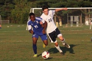 Northport's James McKenna tangles with a Copiague player in a race for possession. Photo by Desirée Keegan