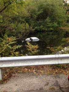 Emergency responders in Smithtown help retrieve a vehicle from the pond off Route 25A near Summerset Drive. Photo from Jeff Bressler
