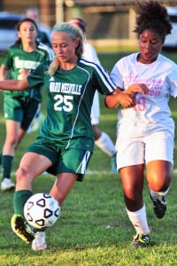 Ward Melville junior midfielder Madison Hobbes is chased for the ball in the Patriots' 6-0 shut out of Brentowod on Oct. 5. Photo by Bill Landon
