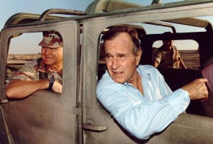 President George H.W. Bush rides in an armored jeep with Gen. H. Norman Schwarzkopf Jr. in Saudi Arabia, Nov. 22, 1990. Photo in the public domain