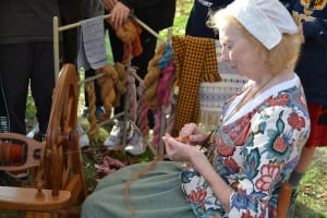 Dixie Francis works with a spinning wheel in front of students on Nov. 9