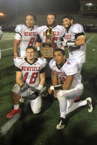Newfield’s Elijah Riley, Joe Saladino, Nick Favaloro, Steven Hoynacky and Isaiah Israel pose with the Long Island Class II football championship trophy after defeating MacArthur, 41-33, on Nov. 27 at Hofstra University. Photo by Newfield High School Video Club
