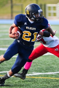 Shoreham-Wading River senior running back Justin Squires makes a move during the Wildcats’ 42-13 win over Center Moriches to earn their second consecutive undefeated season. Photo by Bill Landon