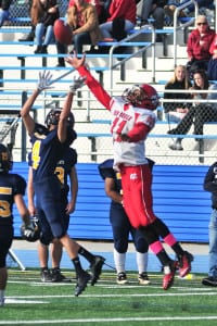 Shoreham-Wading River senior cornerback Kyle Fehmel leaps up for the interception of Center Moriches’ Hail Mary pass during the Wildcats’ 42-13 win over Center Moriches to earn their second consecutive undefeated season. Photo by Bill Landon