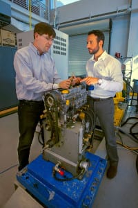 From left, Benjamin Lawler and Sotirios Mamalis with the prototype engine they will use in their Department of Energy-backed research.  Photo from SBU