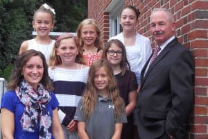 Tom Meehan, far right, poses with singers from the elementary school at the fire department’s annual 9/11 memorial ceremony in September. File photo