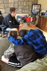 Dunia Sibomana hugs Eian Crean while playing with Collin Crean. Photo from Amy Epstein