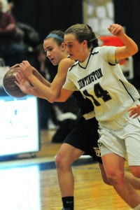 Huntington's Taylor Moreno tries to force a turnover from Smithtown's Jillian Unkenholz. Photo by Bill Landon