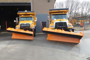 New dump trucks from the Huntington Highway Department with plows on display at a press conference on Dec. 11. Photo by Victoria Espinoza.