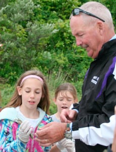 Principal Tom Meehan studies marine life with students at West Beach in Port Jefferson. File photo