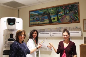 Donna Spolar and Darlene Rastelli from the Carol Baldwin Breast Care Center of Stony Brook and Splashes of Hope artist Sarah Baecher stand in front of a mural. Photo from Heather Buggee
