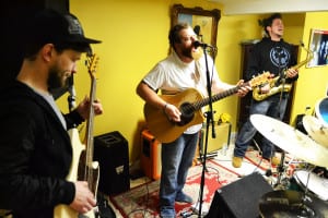 Bassist Ryan McAdam, lead singer Mike Renert and saxophonist Billy Hanley practice at a Gnarly Karma rehearsal on Jan. 12. Photo by Alex Petroski