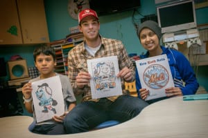 Steven Matz poses with Stony Brook Children’s patients Nicholas Reinoso, left, and Anmol Jaswal, both displaying their Mets-themed colored drawings, which Matz autographed. Photo from Greg Filiano