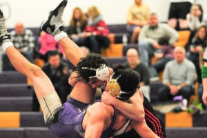 Mount Sinai senior Daniel Henry lifts up his 160-pound competitor during his 11-3 major decision on Jan. 22. The Mustangs topped Sayville 62-15 to end the season in a three-way tie for first in League VI. Photo by Bill Landon