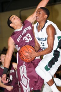 Malcolm Wynter plows his way through traffic to the hoop. Photo by Bill Landon