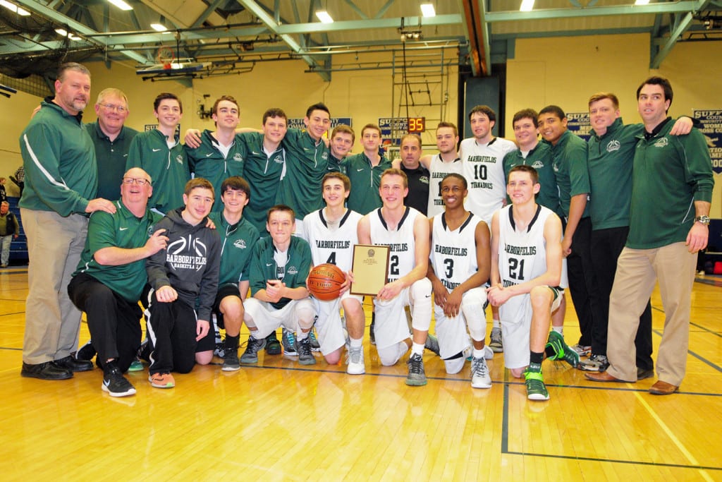 The Harbofields boys' basketball team poses for a group photo with their championship plaque. Photo by Bill Landon