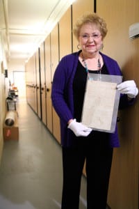  Jo-Ann Raia displays one of the many old town records inside the town archive room. Photo by Victoria Espinoza.