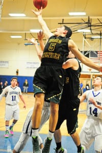Ward Melville junior Dominic Pryor reaches for the ball on a rebound. Photo by Bill Landon