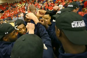 The Stony Brook University men's basketball team huddles together. Photo by John Griffin/Stony Brook University